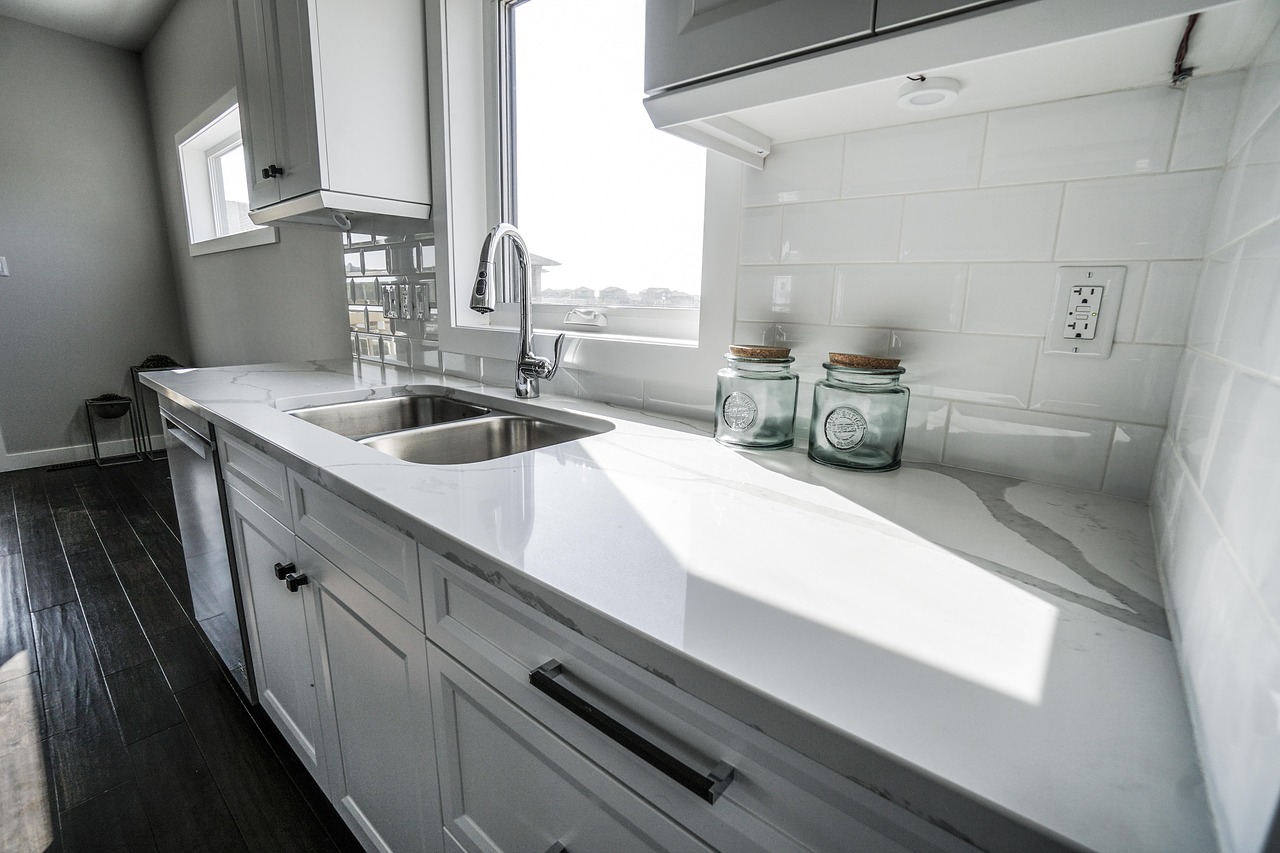 Kitchen after a Whisk clean: scrubbed sink, polished chrome taps, cleared window sill