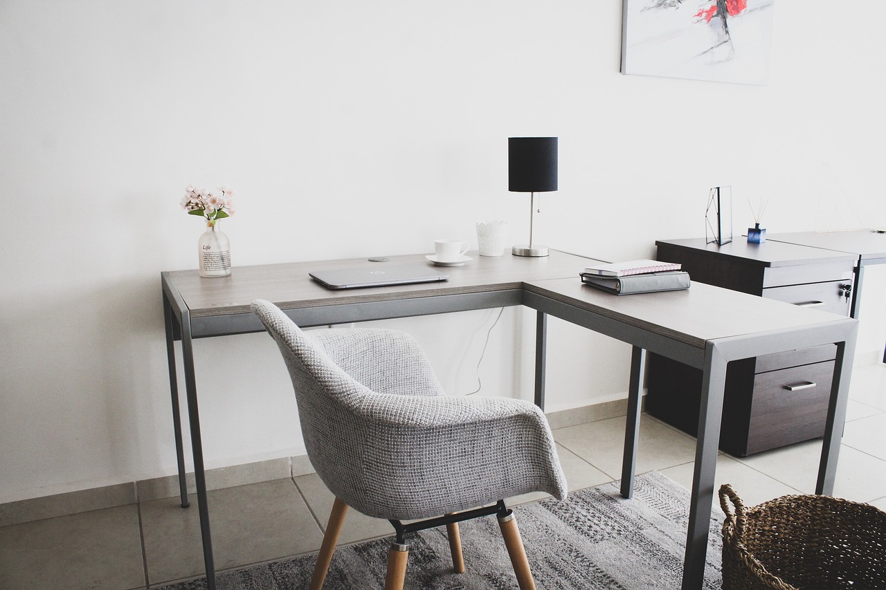 Studio office after a Whisk clean: cleared desk with laptop, phone, and notebook squared away